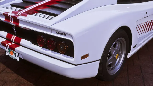 The most informative shot in the bundle. Three round tail lights per side behind a black grille, the Testarossa side strakes in red, and a cursive Cheetah badge. Grotti's prancing horse appears twice, on the rear panel and again on the wheel centre. The number plate reads GOODTIME STATE beneath an orange, which is the clearest look anyone has had at Leonida's plate design.