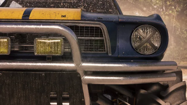 Caked in dried mud. A chrome tube bull bar crosses yellow-lensed driving lamps, and the round headlight behind it is taped over in an X. Taping headlights is what real off-road racers do so a stone strike does not put glass across the track, and it is the sort of detail that gives the build away as genuine rather than decorative.