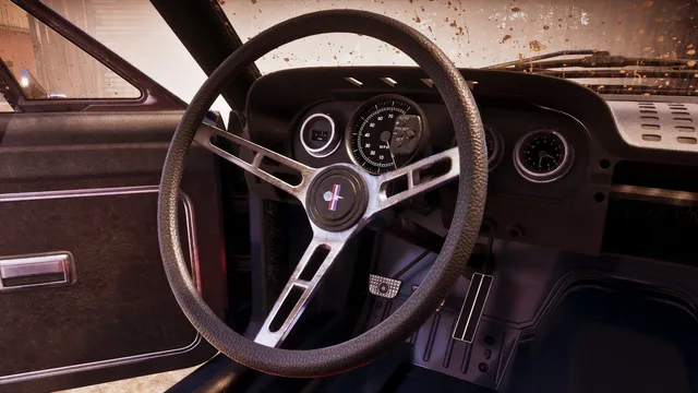 A 1960s cabin behind a splattered windscreen: three-spoke wheel with Vapid's horse and bars badge on the boss, a speedometer, a clock on the passenger side, and a preset radio. A roll cage tube runs across the door opening, which confirms the car was built to be raced rather than dressed to look like it.